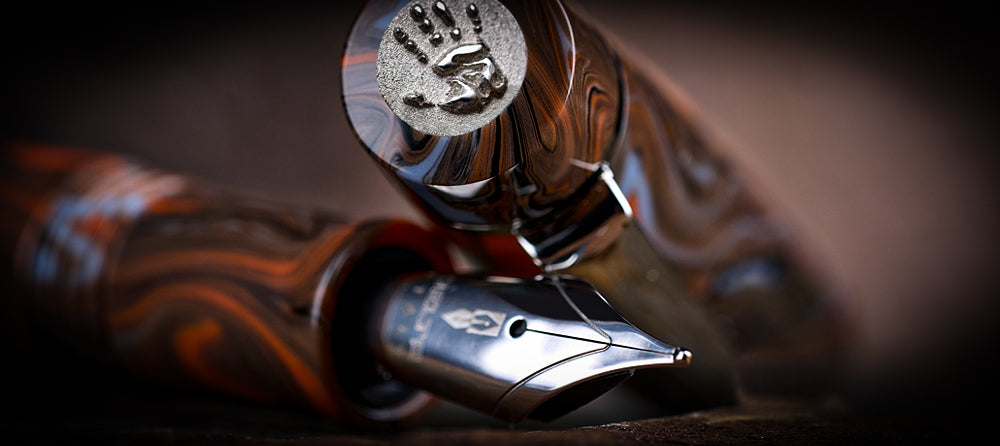 Close-up of delta pen with intricate design on a dark background