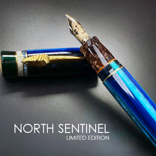 Blue fountain pen with gold accents on a dark gray background, featuring Delta 'North Sentinel' branding.