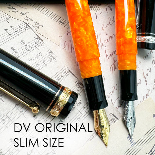 Two fountain pens with orange and black accents on sheet music, labeled 'DV Original Slim Size'.