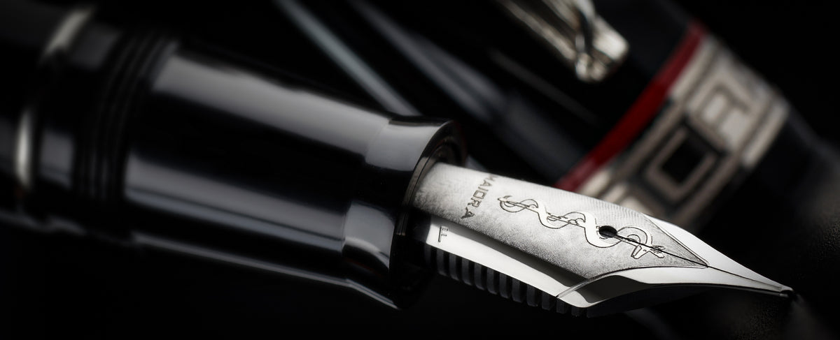 Close-up of a fountain pen nib on a dark background