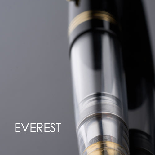 Close-up of a pen with 'Everest' branding on a gray background